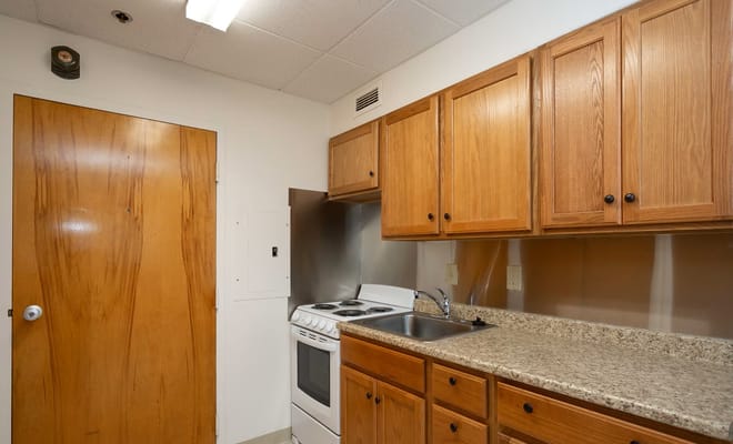 Small kitchen with wooden cabinets and stove