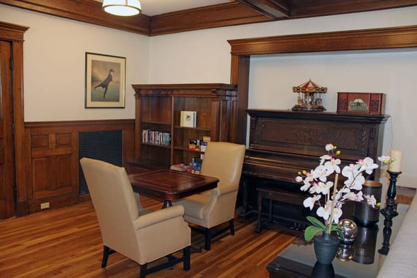 Cozy common area in the facility with seating and piano