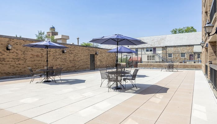 Outdoor patio area with umbrellas and seating