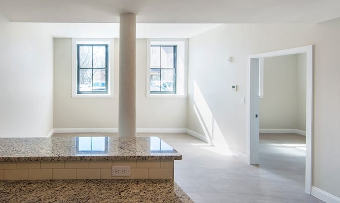 Bright living room with large windows and granite countertop