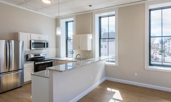 Bright, modern kitchen featuring stainless steel appliances and granite countertops