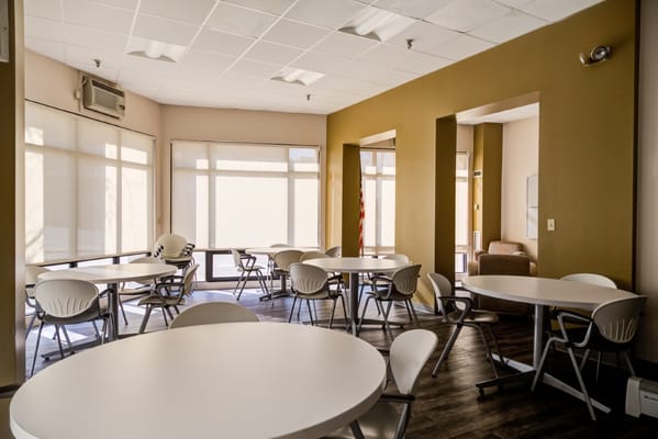 Bright common area with tables and chairs