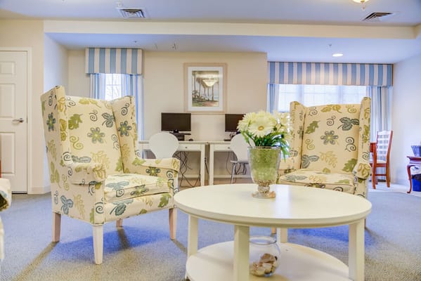 Cozy lounge area with floral chairs and a coffee table