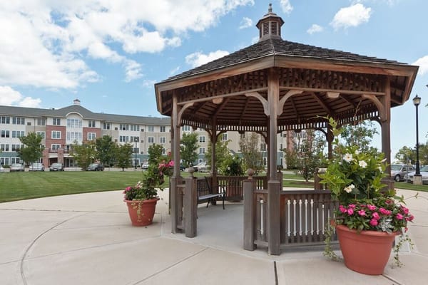 Gazebo surrounded by landscaped gardens and facility buildings