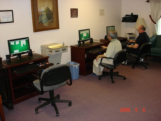 Residents using computers in an activity room