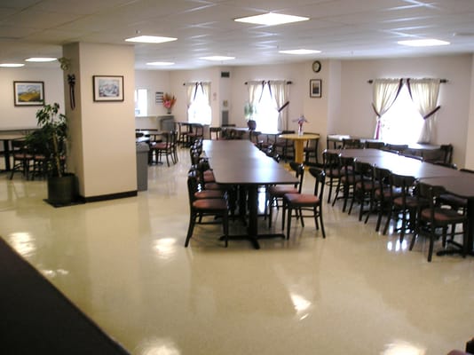 Dining area with tables and chairs in a well-lit room