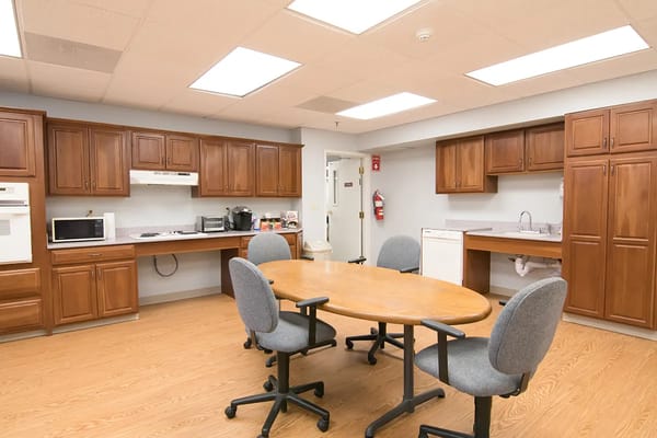 Interior view of a community kitchen area with an eating table