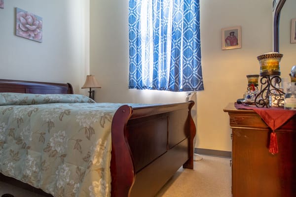 Cozy bedroom with floral bedding and blue curtains