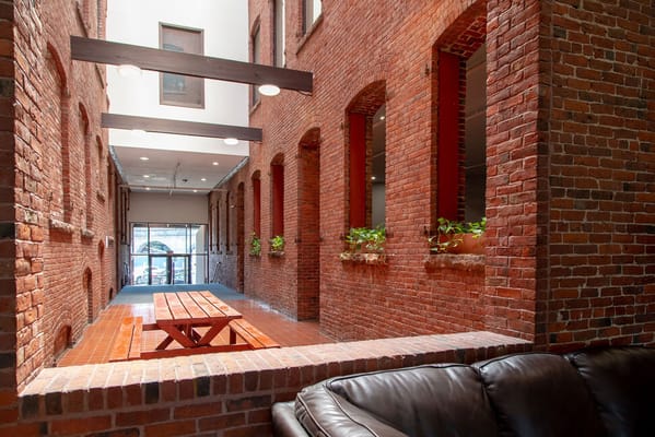 Interior hallway with exposed brick and seating area