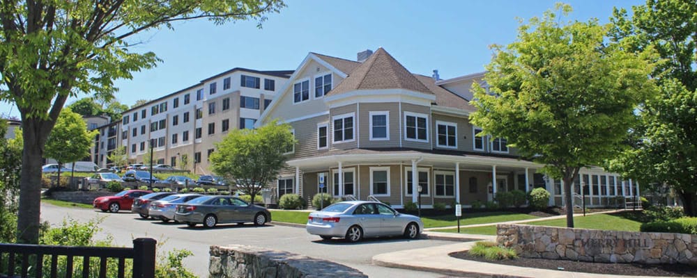 Exterior view of Cherry Hill II with parking and greenery