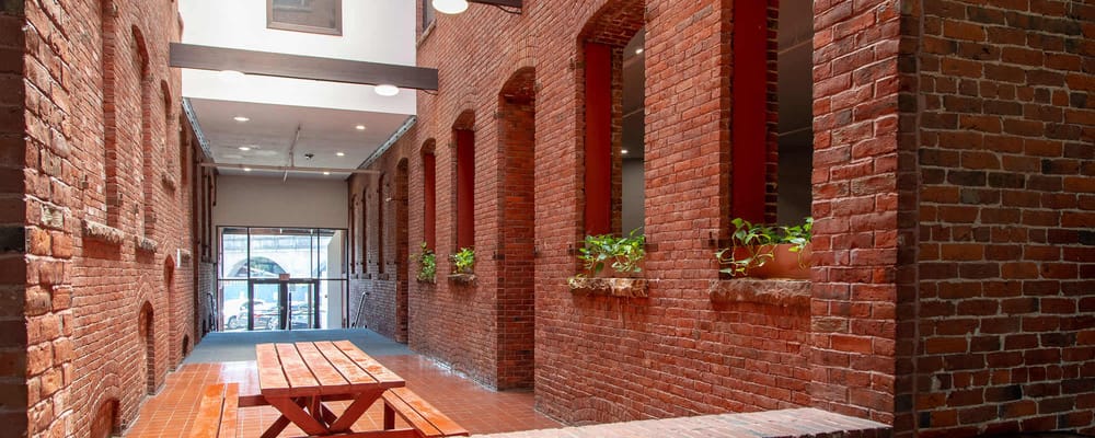 Interior view of a hallway with brick walls