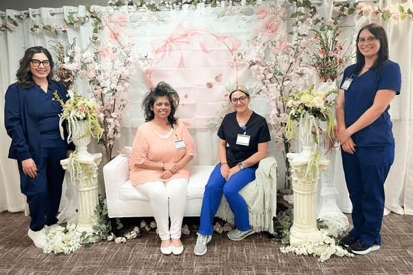 Staff members posing together in a decorated space