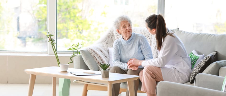 A caregiver and resident engaged in a conversation