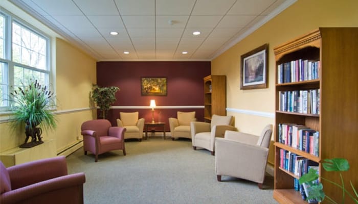 Bright common area with seating and bookshelf