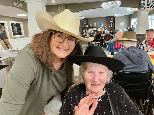 Resident and staff member smiling at an activity event