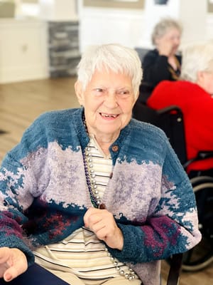 Resident smiling while engaged in an activity