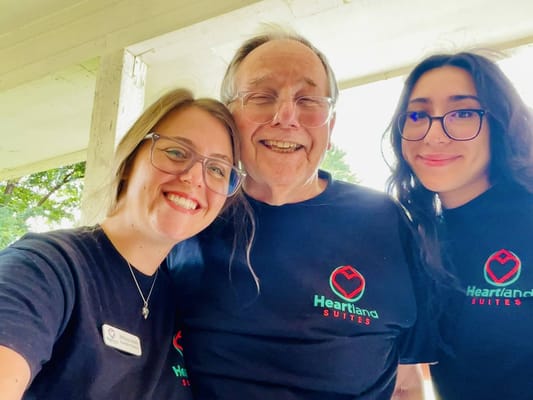 Three people smiling in a shared joyful moment