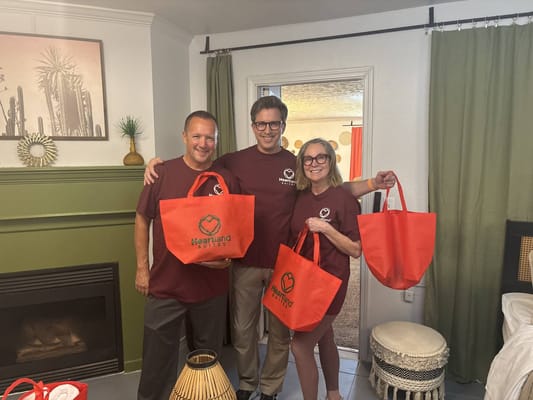 Staff and residents holding welcome bags in a common area