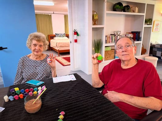 Residents painting in an activity room
