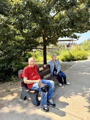Two residents enjoying time outdoors on a bench