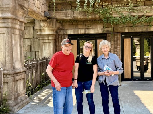 Residents and staff posing outside the facility entrance