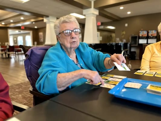 Resident participating in a game activity in the common area