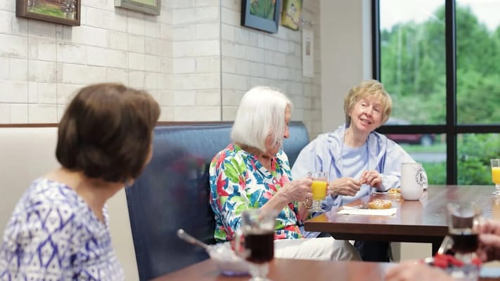 Residents enjoying snacks and drinks in a cozy dining area