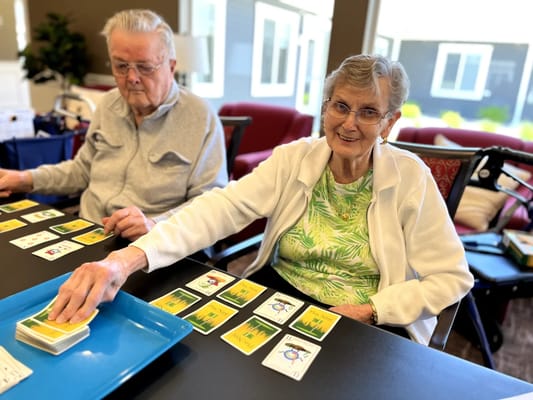 Residents enjoying a card game in a common area