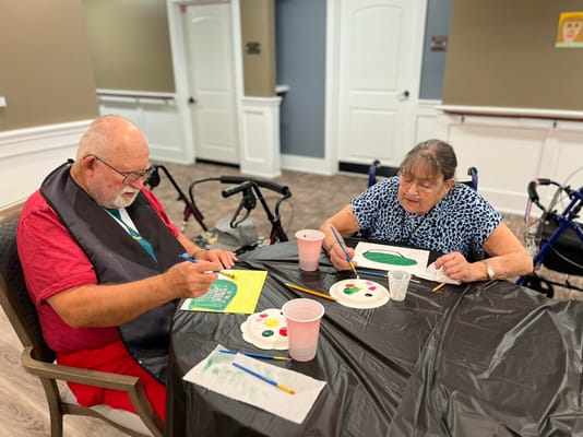 Residents engaged in a painting activity