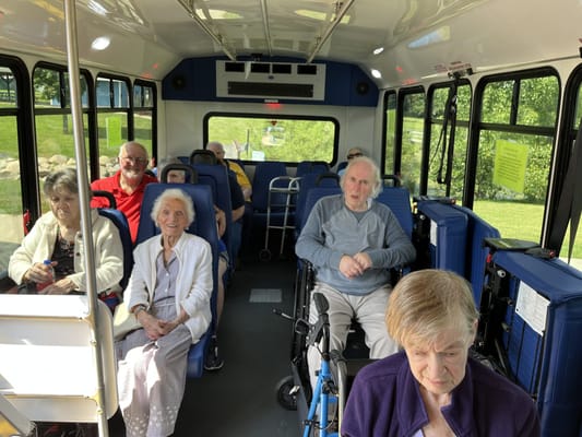 Residents enjoying a bus ride with staff