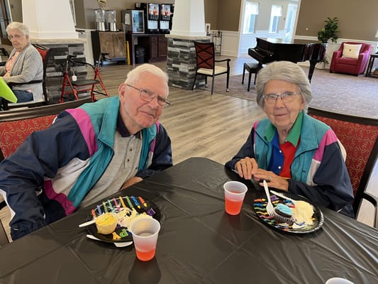 Two residents enjoying cupcakes in a common area