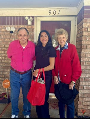 Residents and staff in front of the facility entrance