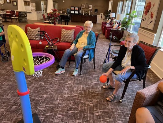 Residents enjoying a basketball game in the activity room