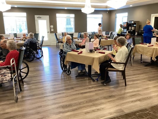 Residents dining in a bright dining room