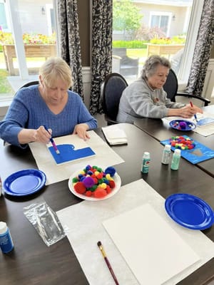 Residents engaging in an art activity at a table