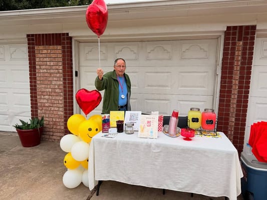 Resident celebrating with decorations and balloons outdoors