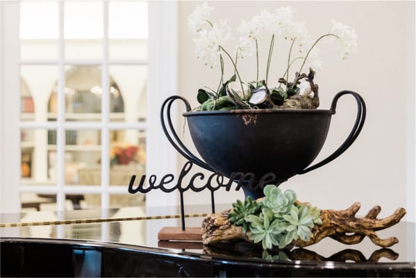 Decorative welcome sign with flowers in a common area