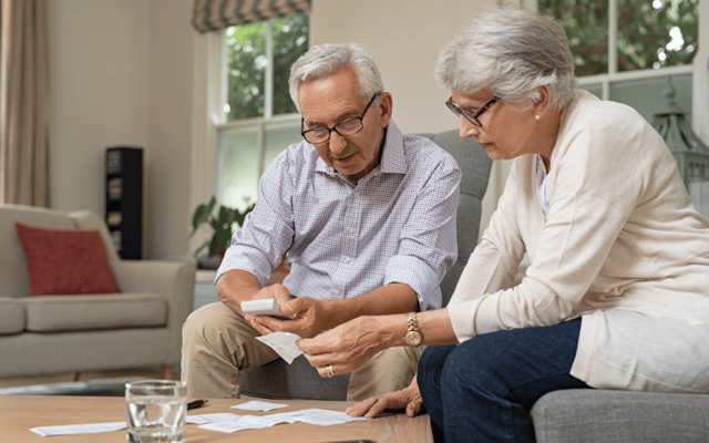 Seniors engaged in an activity together in a cozy room