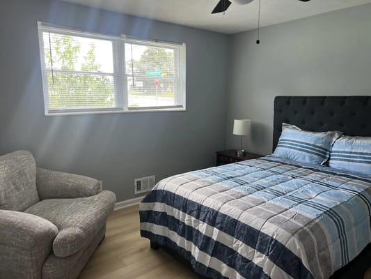 Cozy private room with a bed and armchair