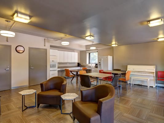 Spacious common room with seating and dining areas.