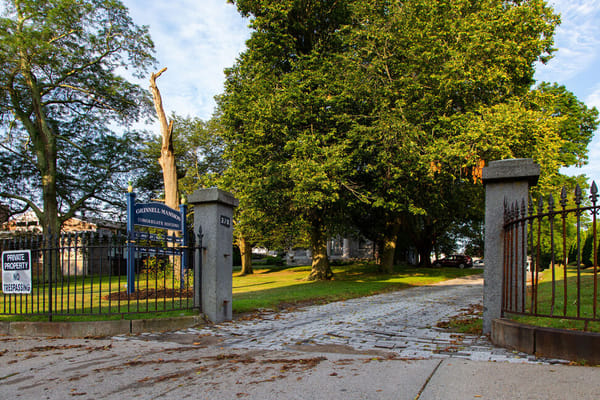 Entrance pathway to Grinnell Mansion with landscaped trees