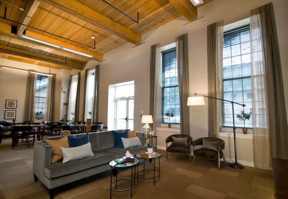Cozy common area with a sofa and natural light