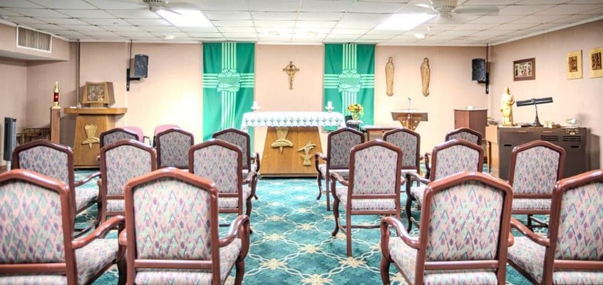 Chapel interior with chairs and altar at River Falls Senior Living