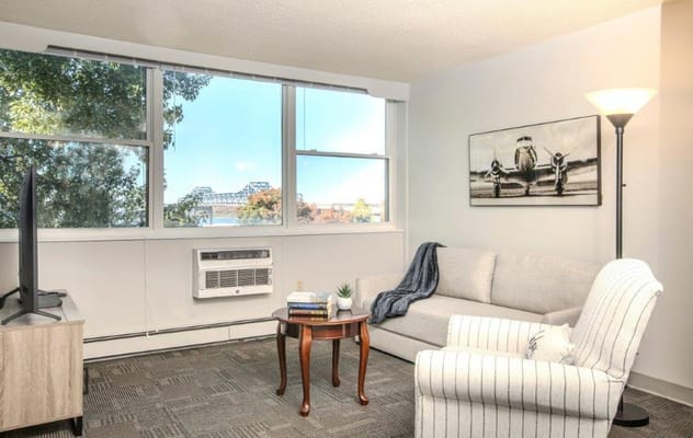Bright living room featuring a sofa and view of the outdoors