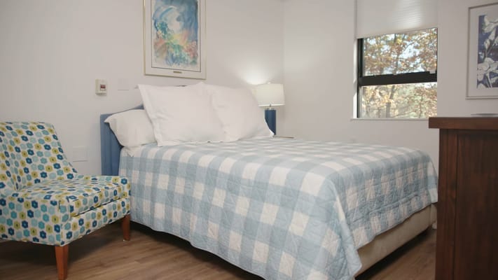 A bright, inviting resident room with light decor