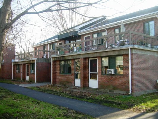 View of the brick exterior of Norumbega Gardens with balconies