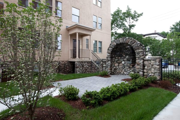 Stone archway at the garden entrance of Sacred Heart Apartments