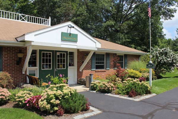 Exterior view of the assisted living facility with flower gardens
