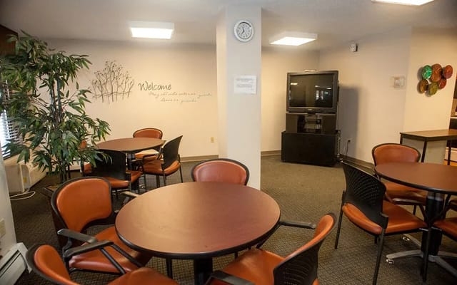 Lounge area with tables and chairs in a common room