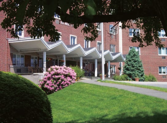 Exterior view of the facility with landscaped gardens